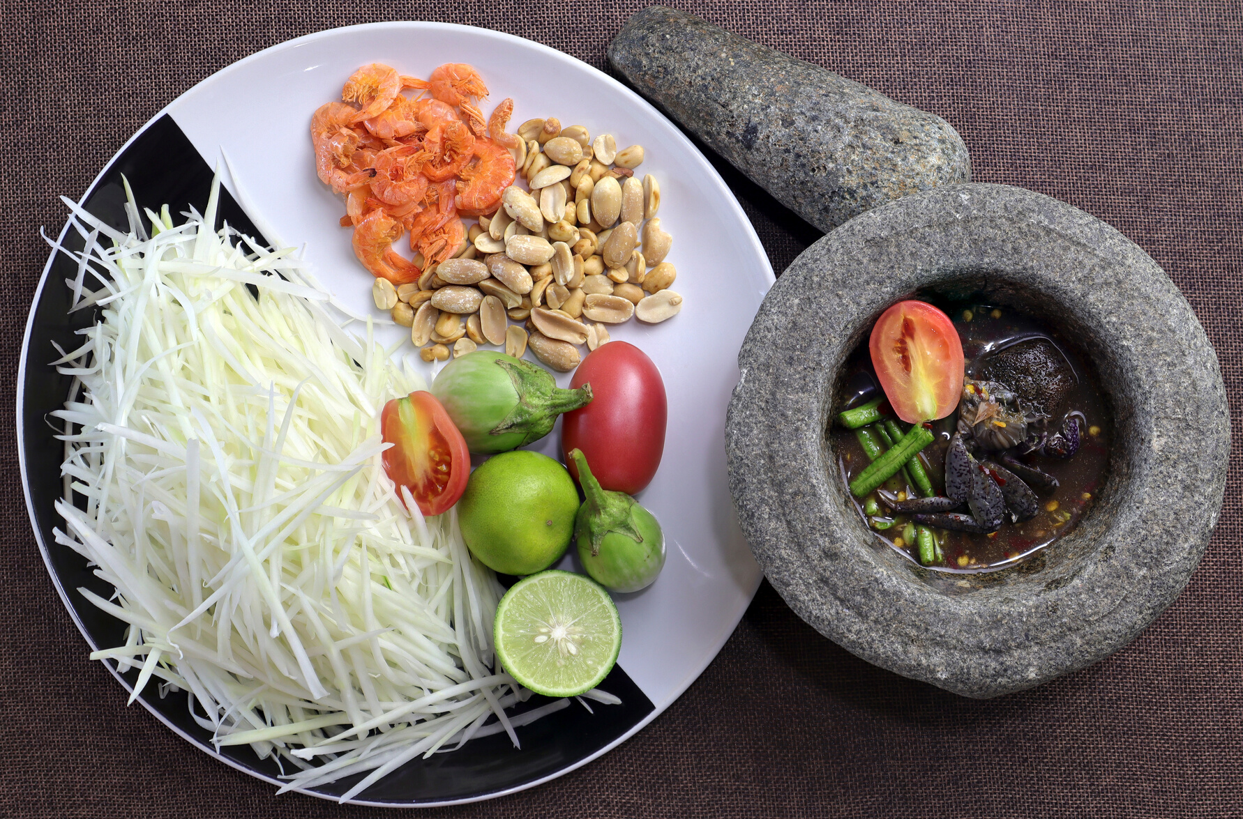 (Som Tam Thai)   papaya salad. Ingredients Papaya Salad, chopped papaya, dried shrimp , lemon, tomatoes, dried peanuts. Thai Food Concept. Top View