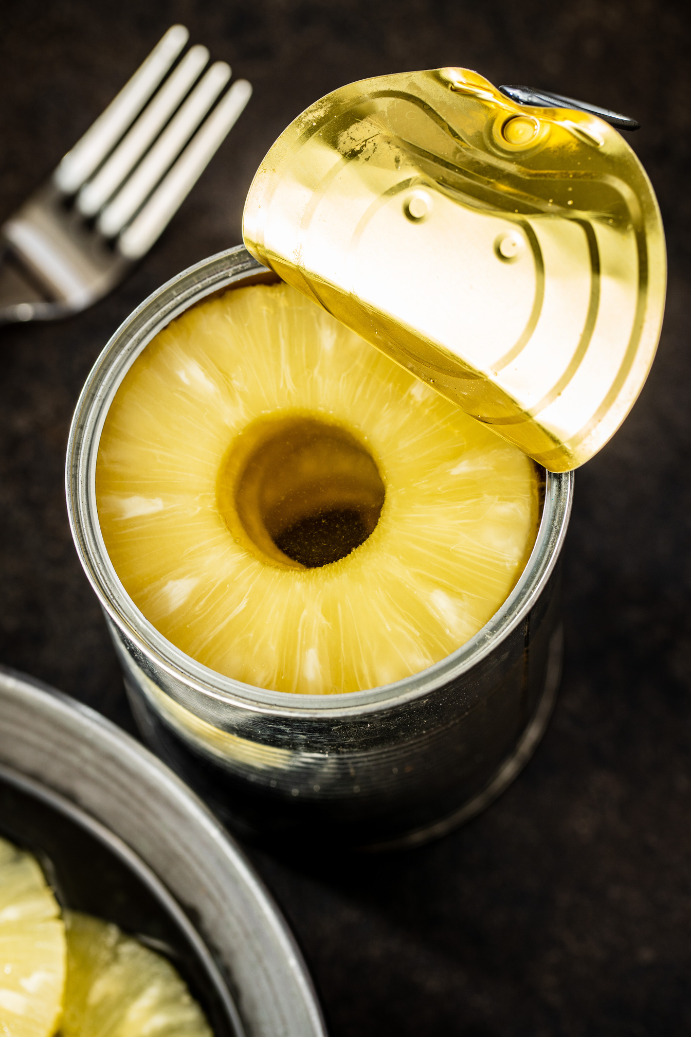 Canned sliced pineapple fruit in can.